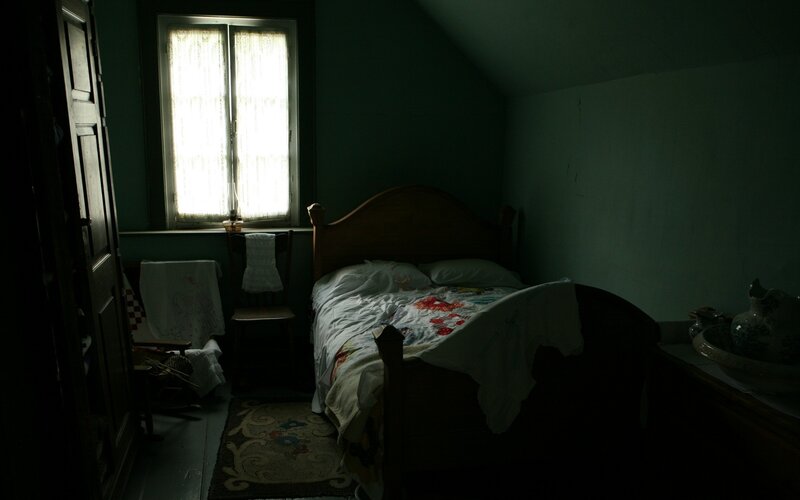 dimly lit bedroom with bed