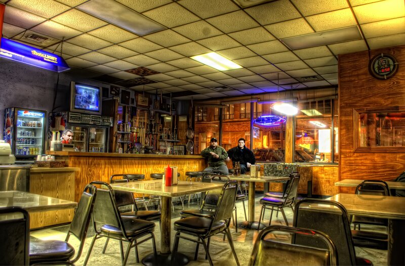 diner with patrons and neon signs