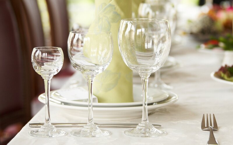 Dinner table setting with wine glasses