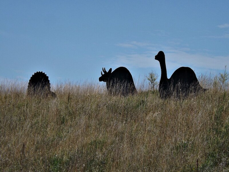 Dinosaur Sculptures in Field