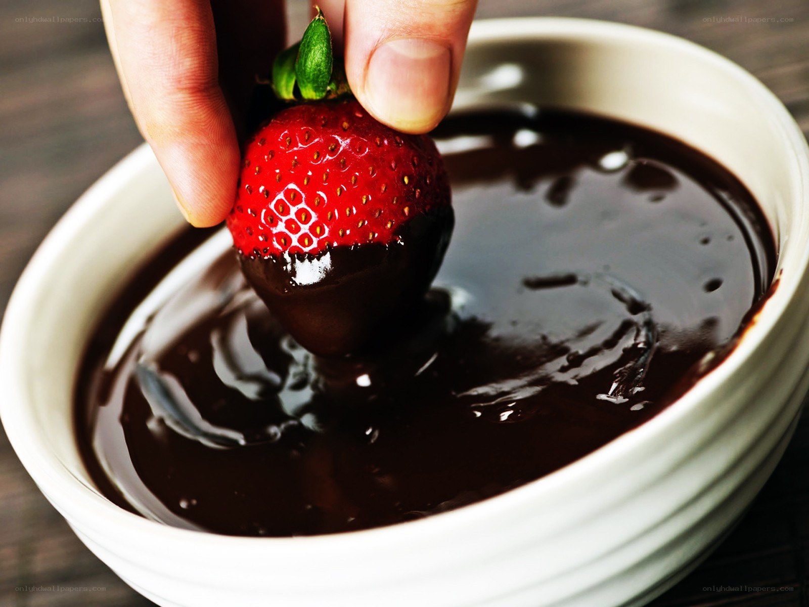 dipping strawberry in chocolate