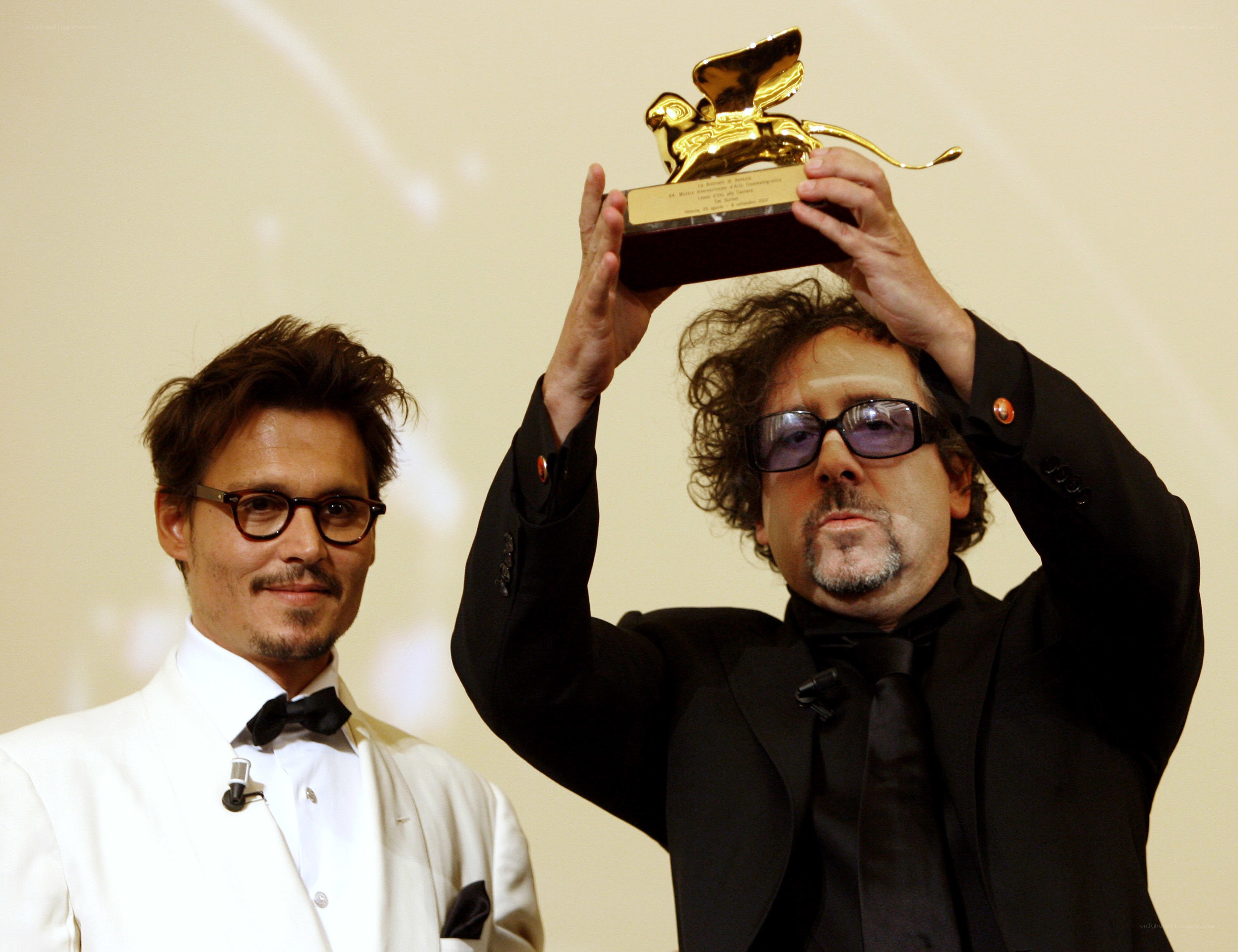 director holding award with actor