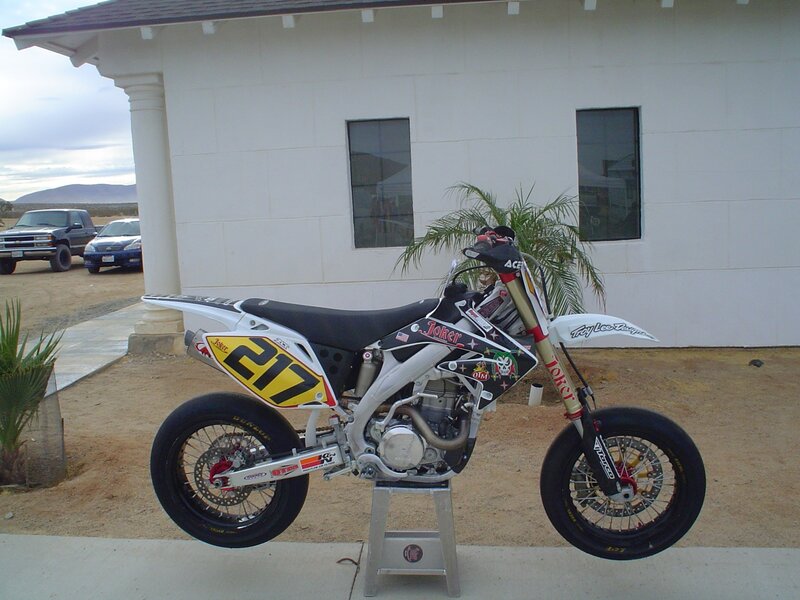 dirt bike on stand outside house