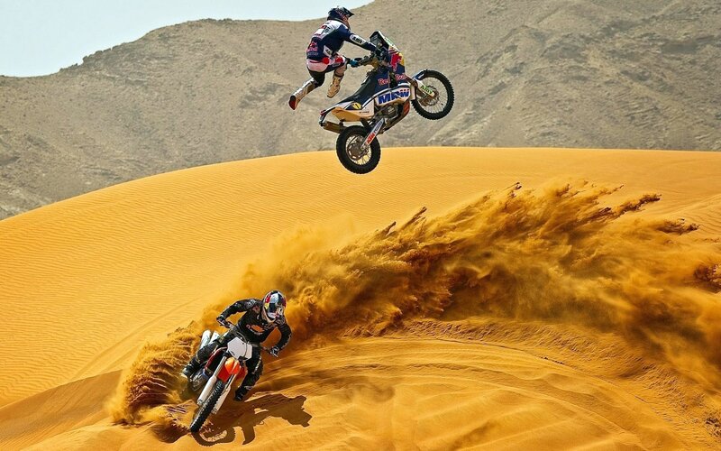 Dirt bike riders on sand dunes