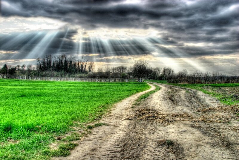 Dirt path under dramatic sky
