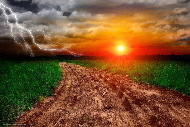 Dirt path under stormy sunset
