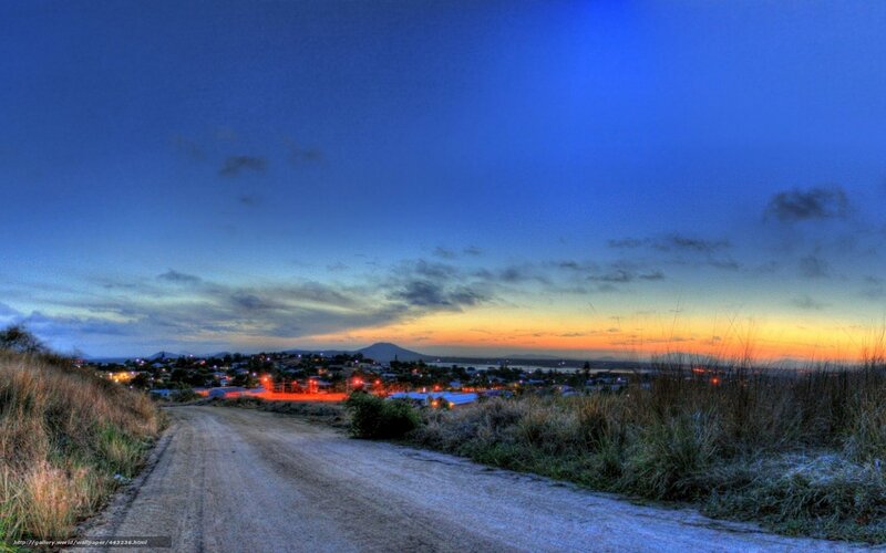 Dirt road at dusk overlooking town