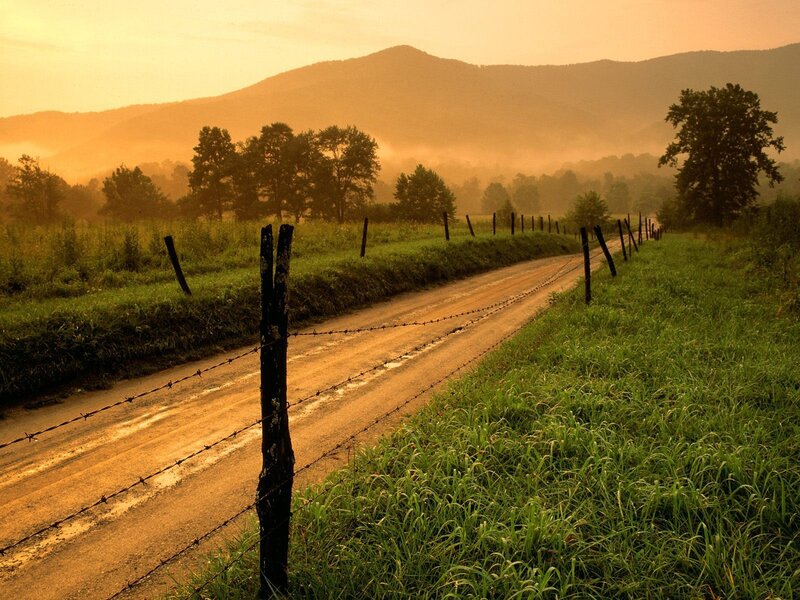 Dirt road at sunrise in the mountains