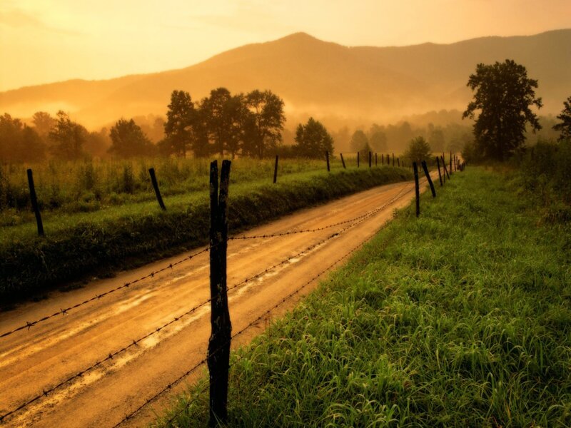 Dirt road at sunrise in the mountains
