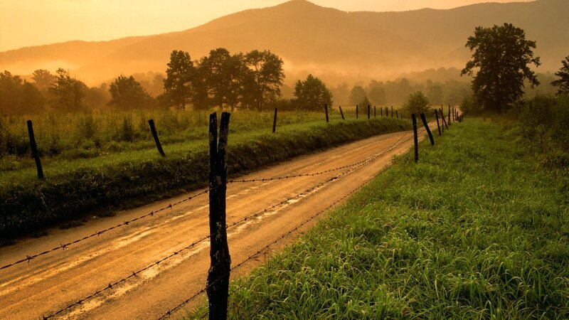 Dirt road at sunrise in the mountains