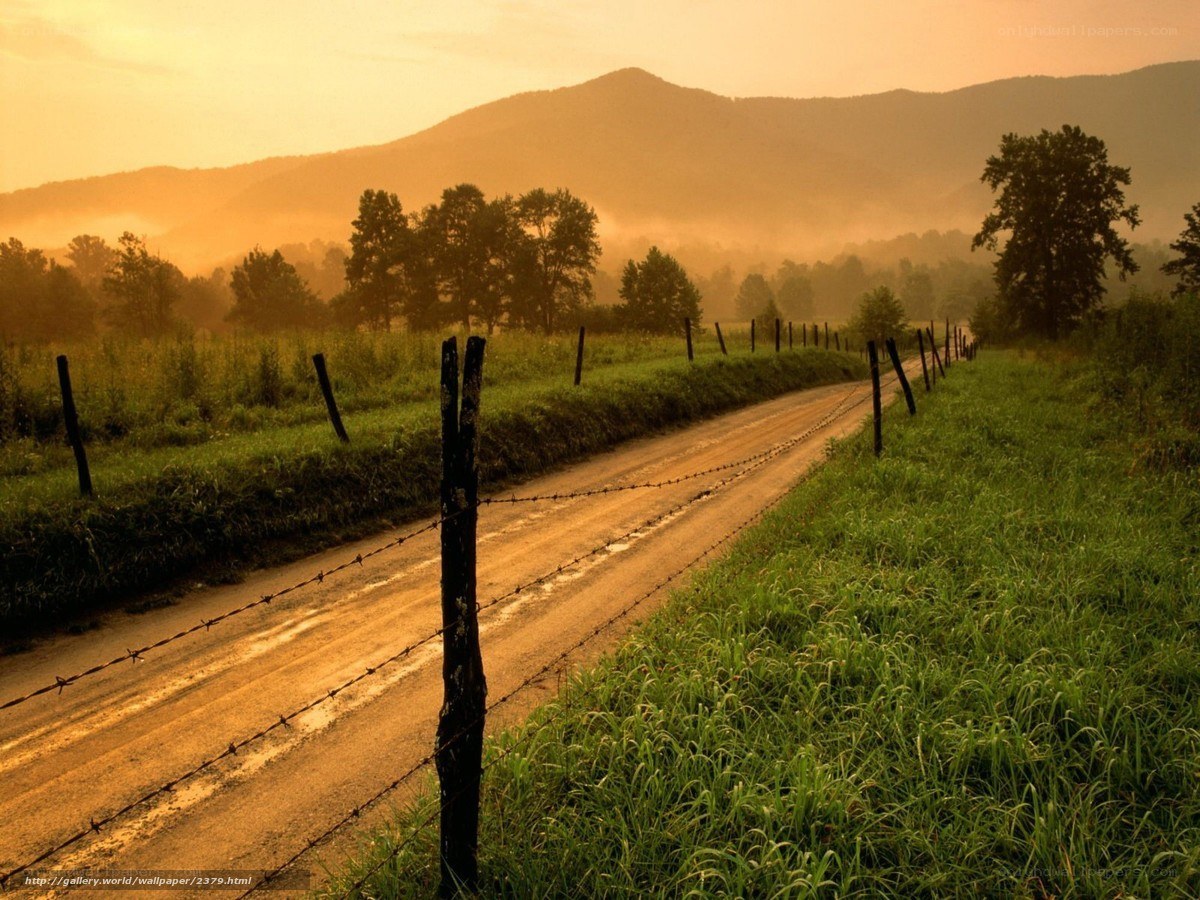 Dirt road at sunrise with mountains