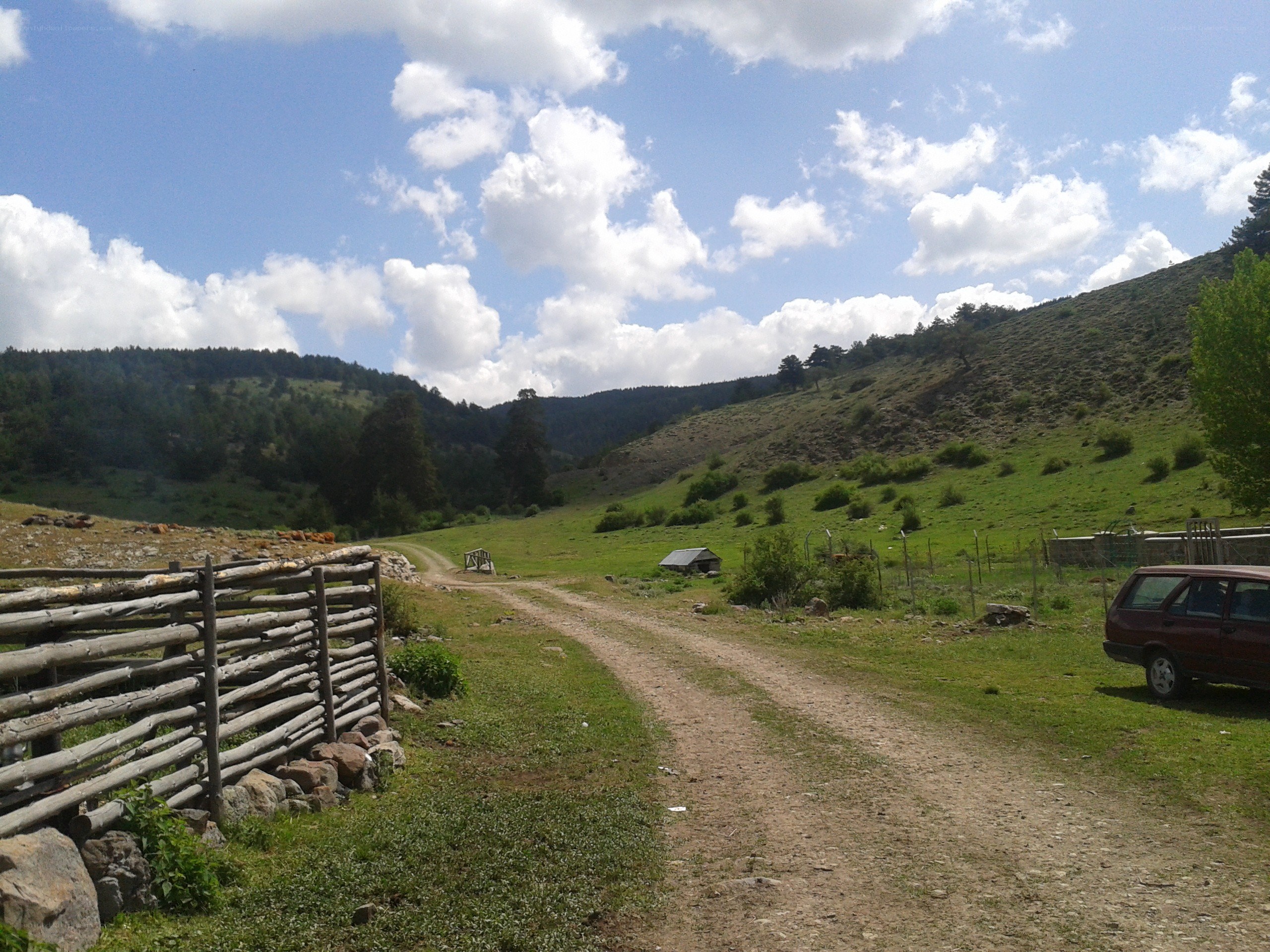 Dirt road in a green valley