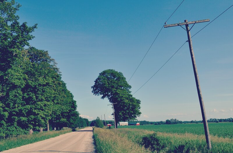 Dirt Road in Countryside — Green, Serene, Afternoon, Photograph, Trees, Power Lines