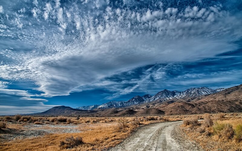 Dirt Road in Desert — Blue, Dramatic, Afternoon, Photograph, Mountains