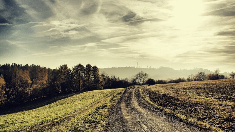Dirt road through autumn hills