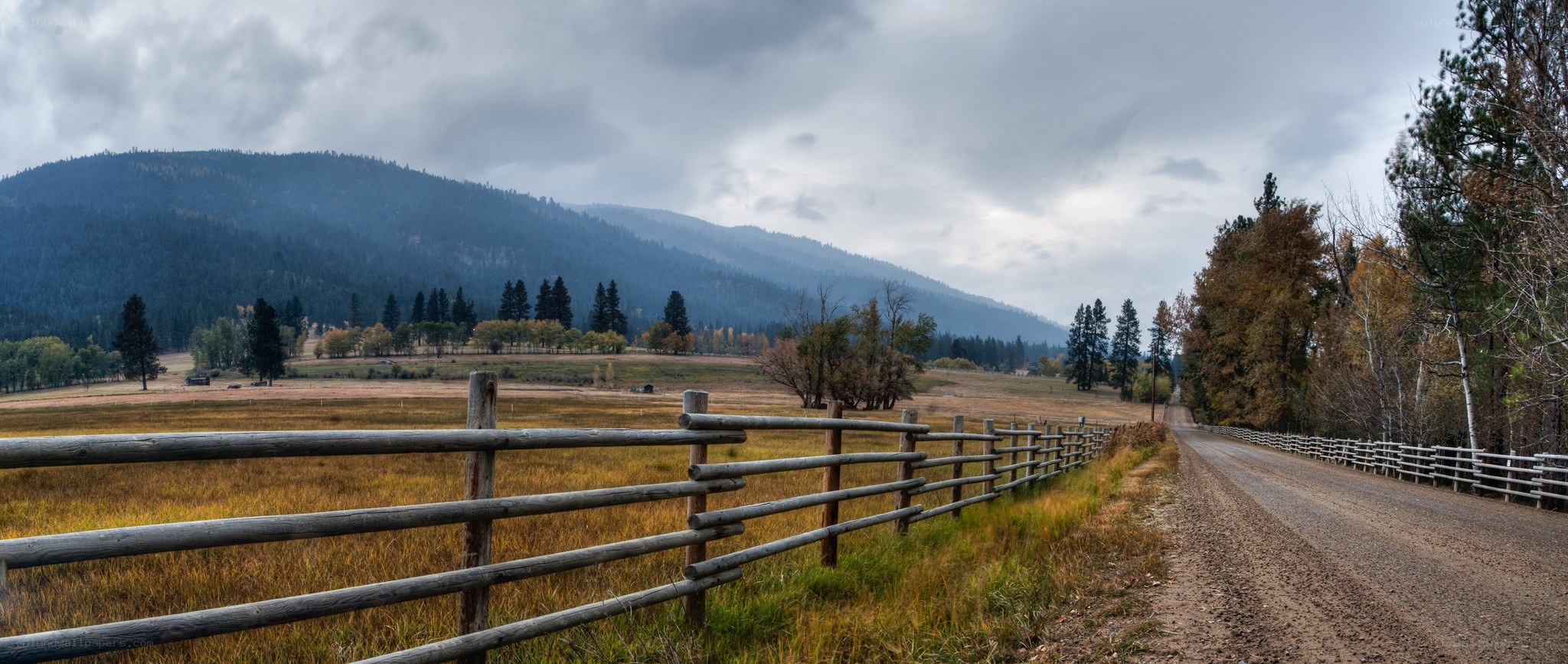 Dirt road through autumn valley