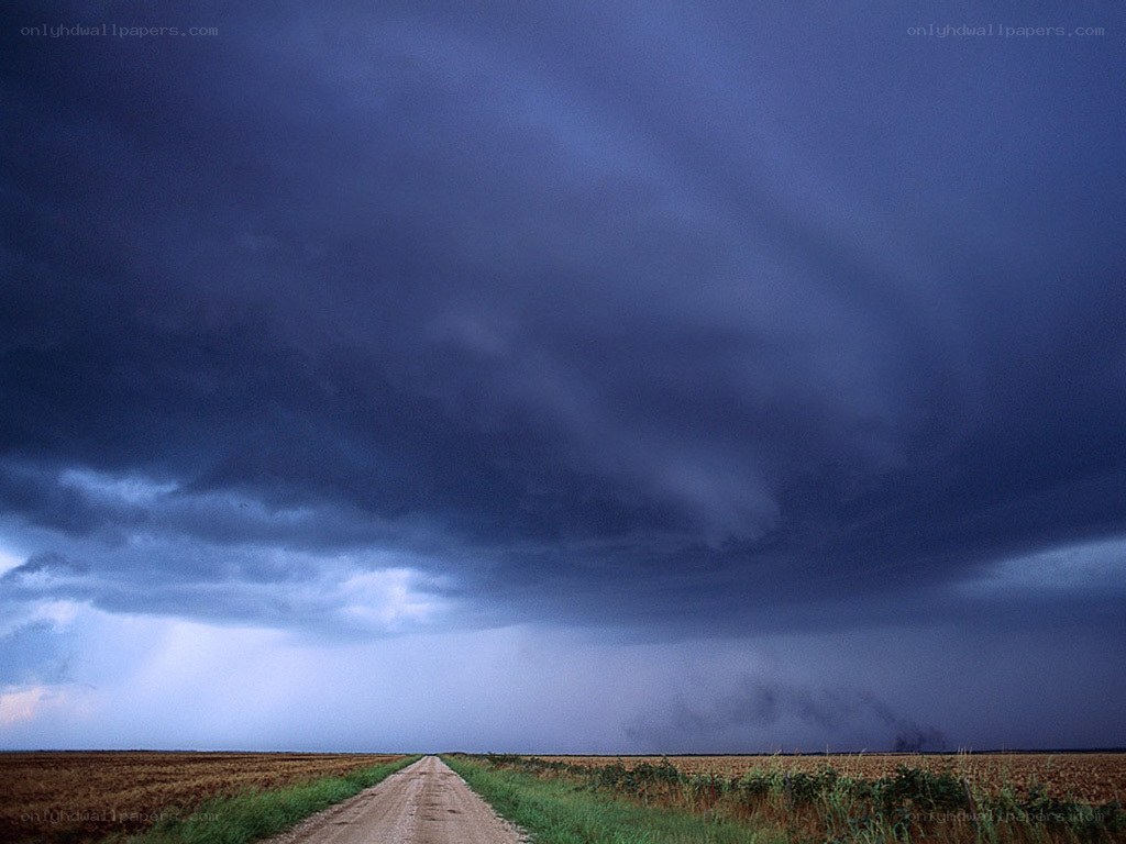 Dirt road under storm clouds