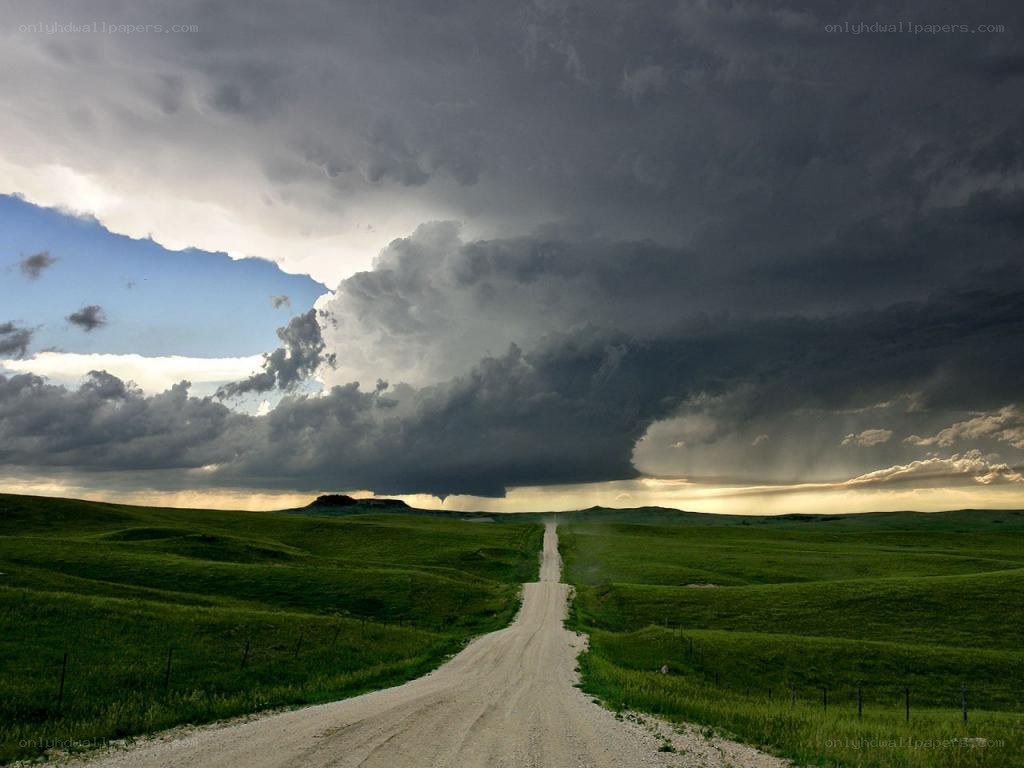 Dirt road under storm clouds