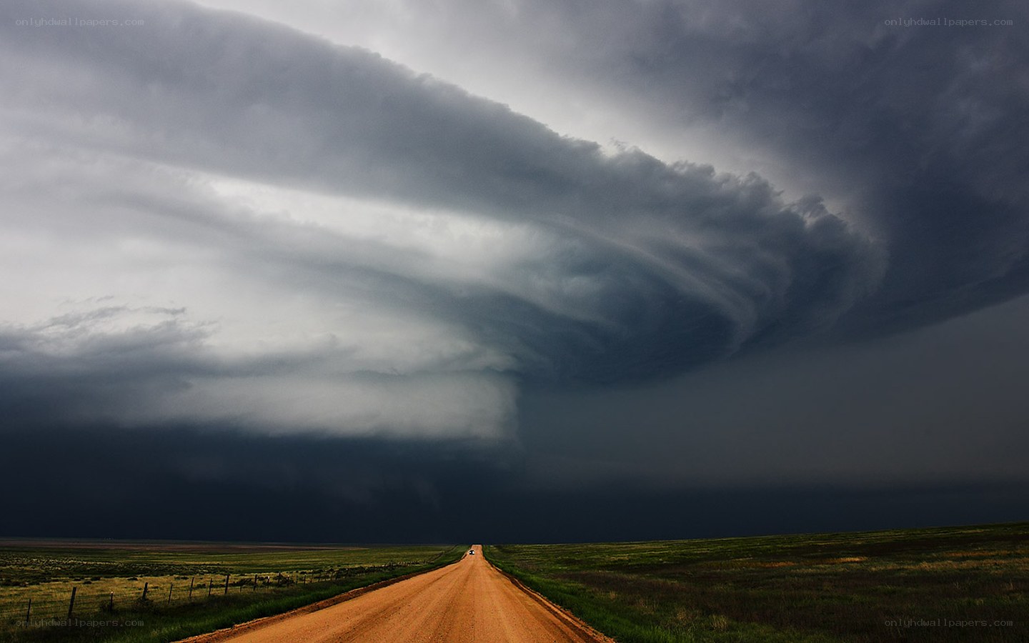 Dirt road under storm clouds