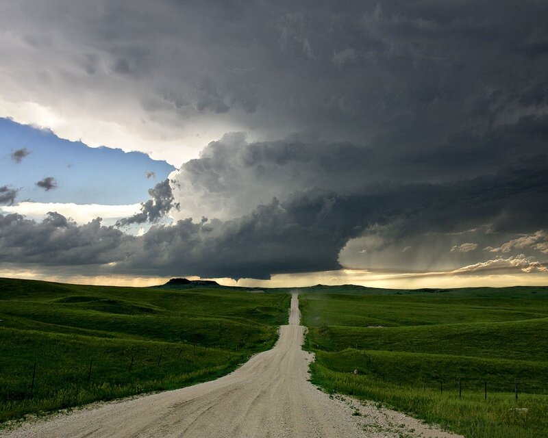 Dirt road under storm clouds