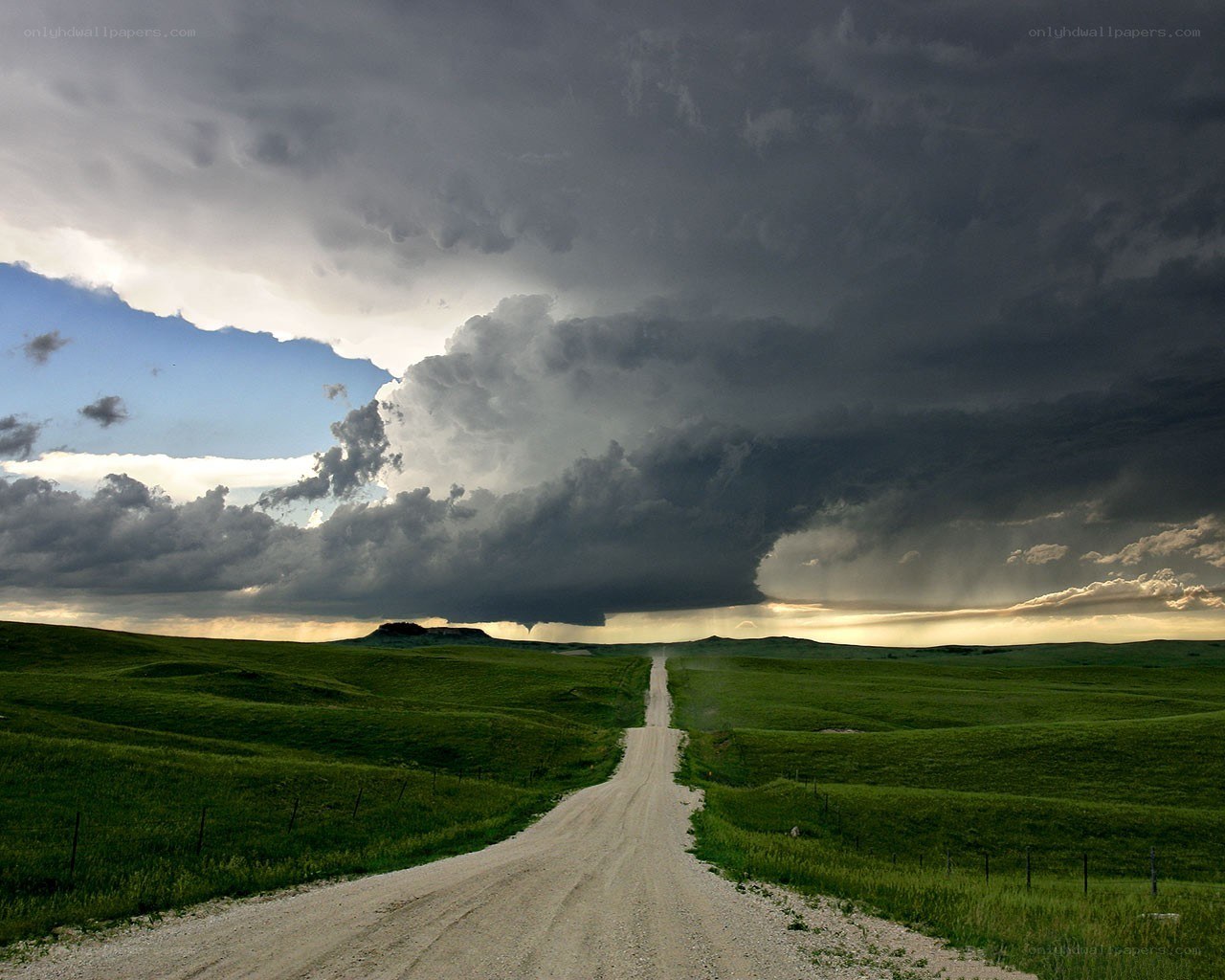 Dirt road under storm clouds