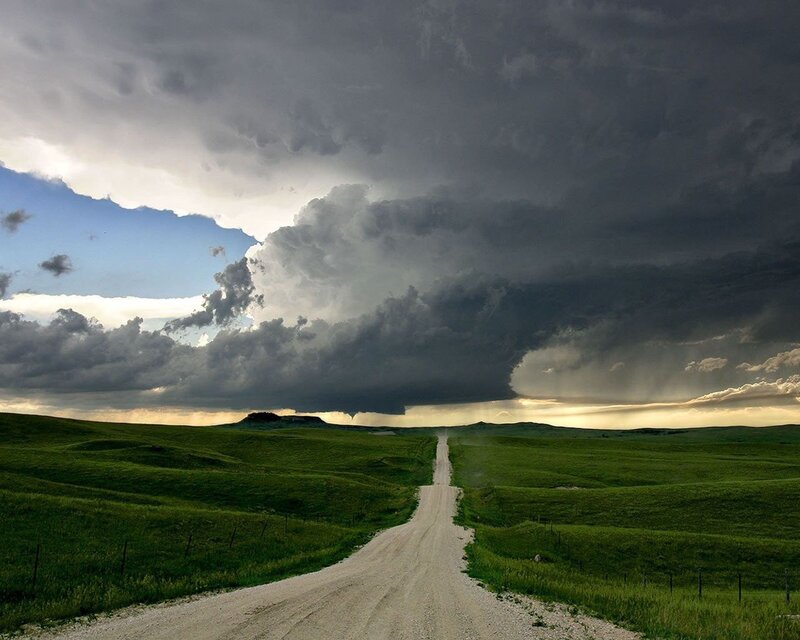 Dirt road under storm clouds