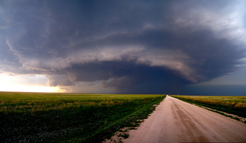 Dirt road under storm clouds
