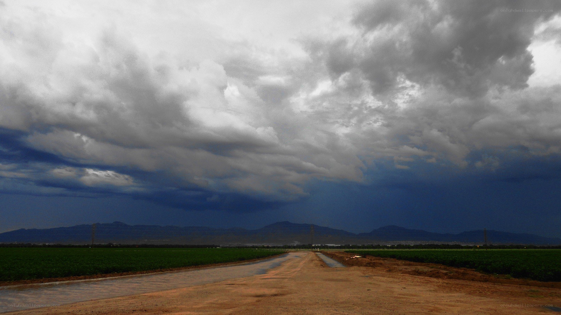 Dirt road under stormy sky