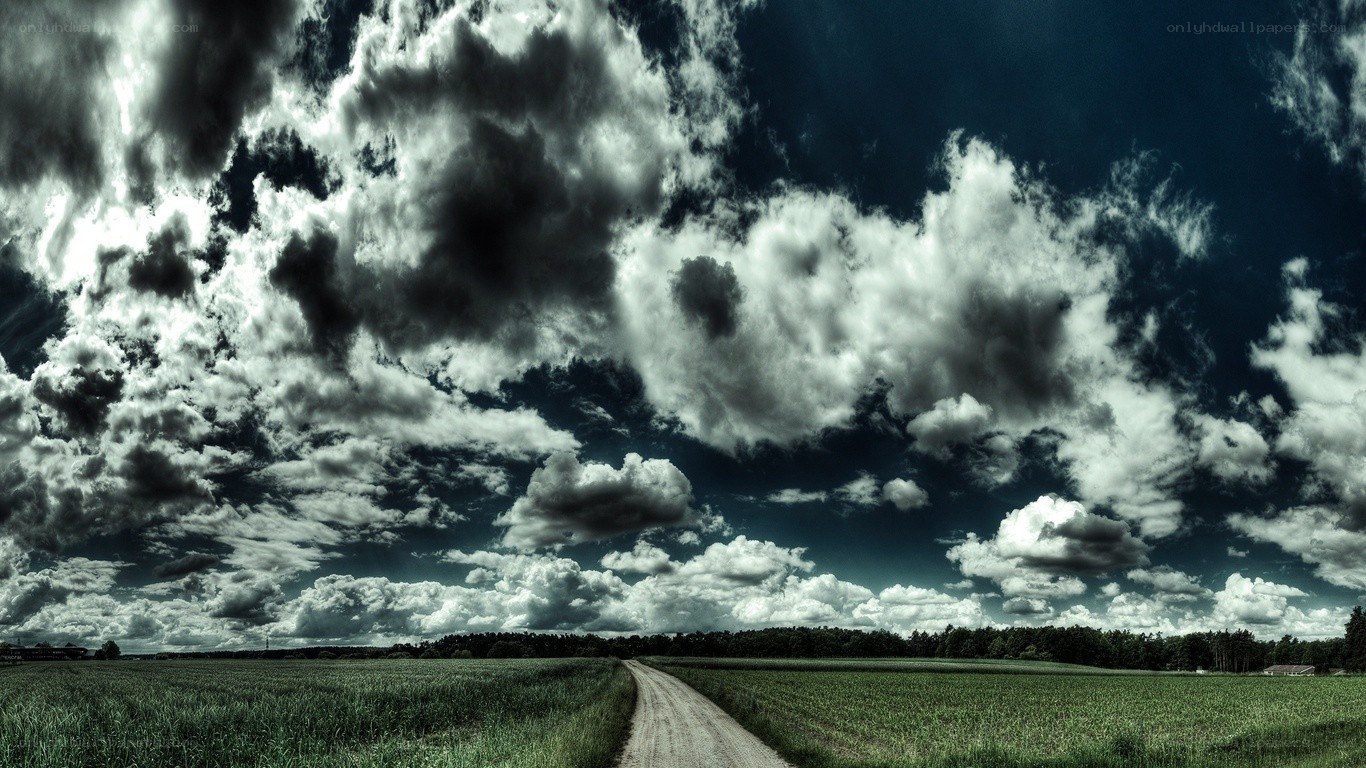 Dirt road under stormy sky
