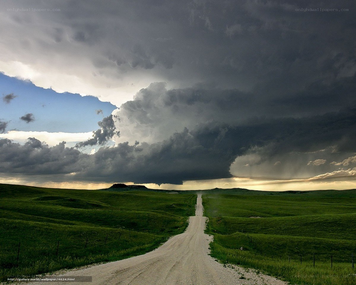 Dirt road under stormy sky