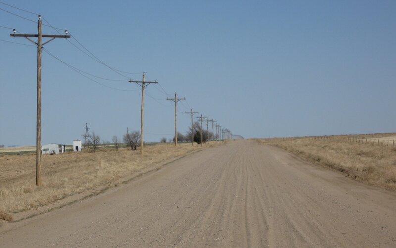 Dirt road with power lines