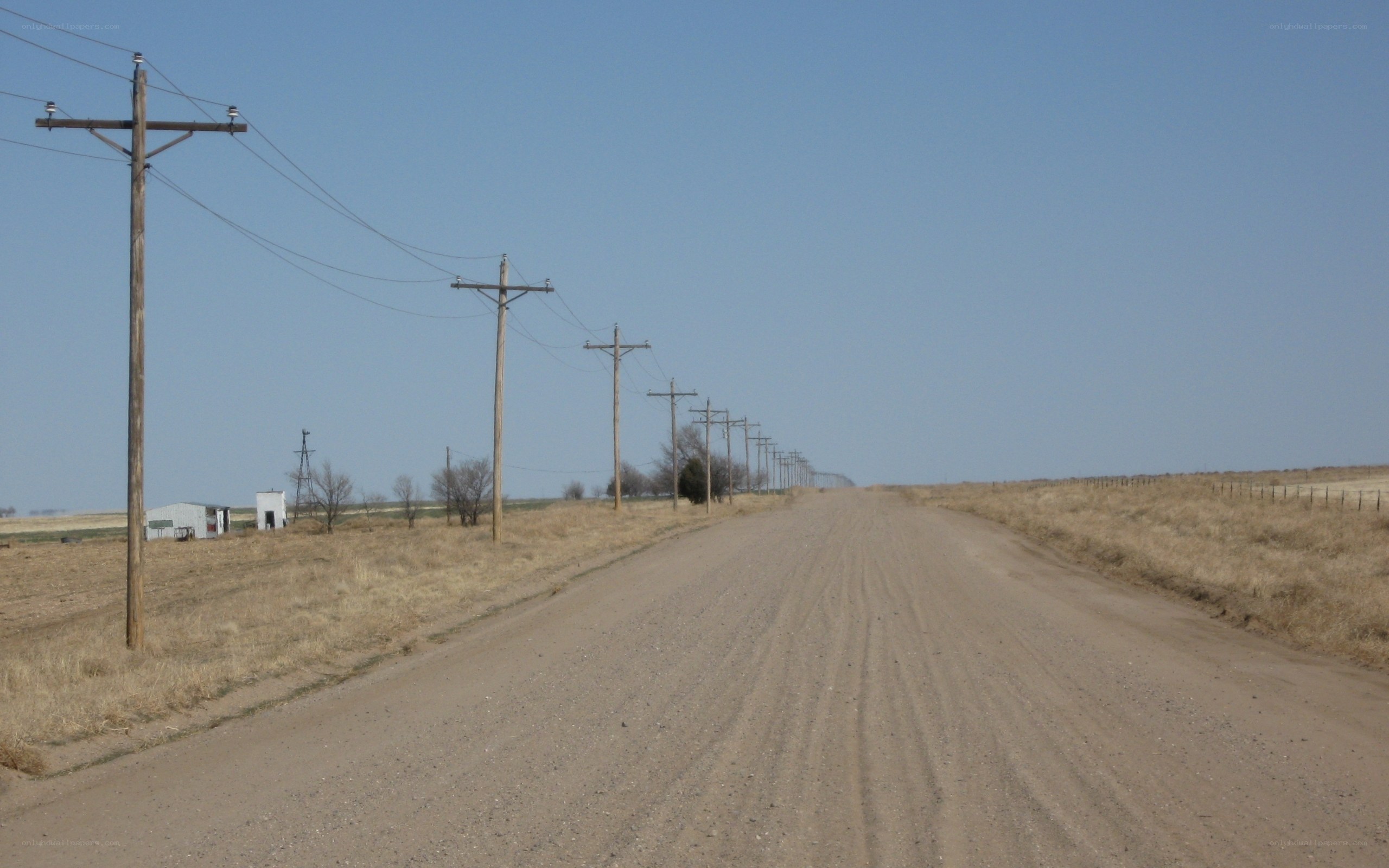 Dirt road with power lines