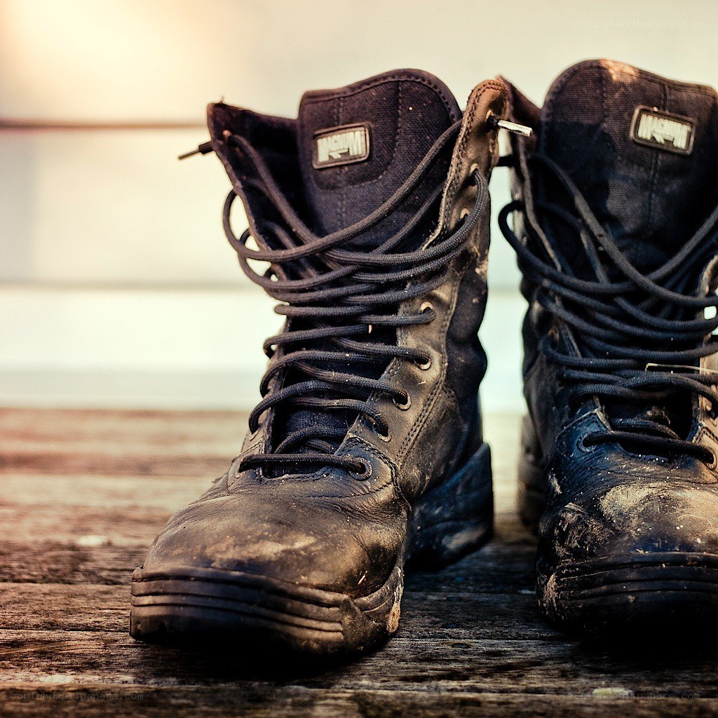 dirty combat boots on wood