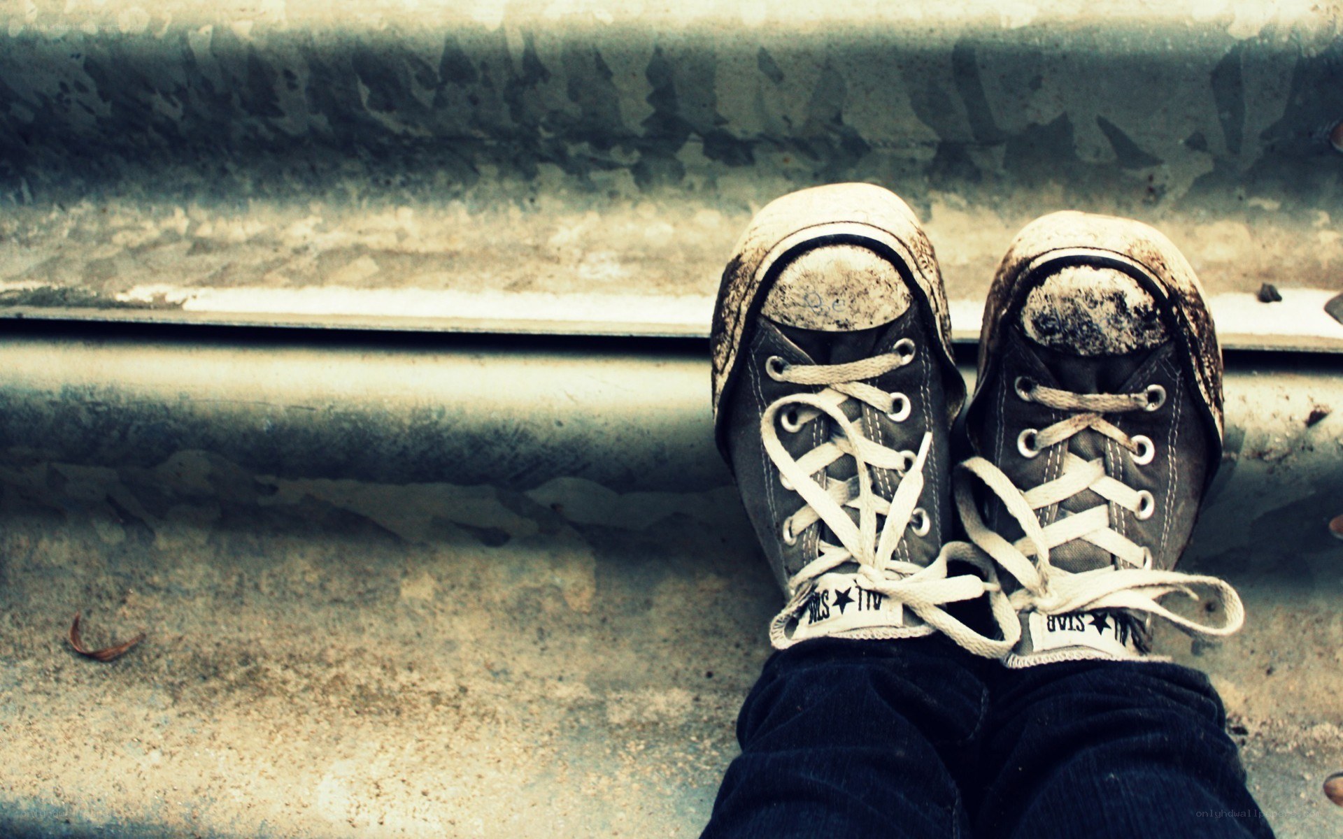 dirty sneakers on a bench