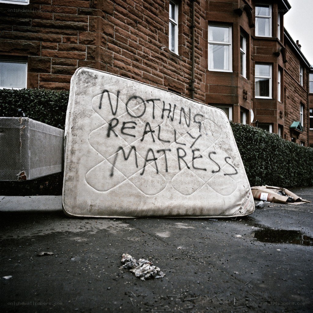 Discarded mattress with graffiti