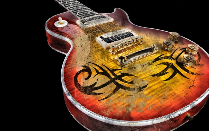 distressed electric guitar with tribal design