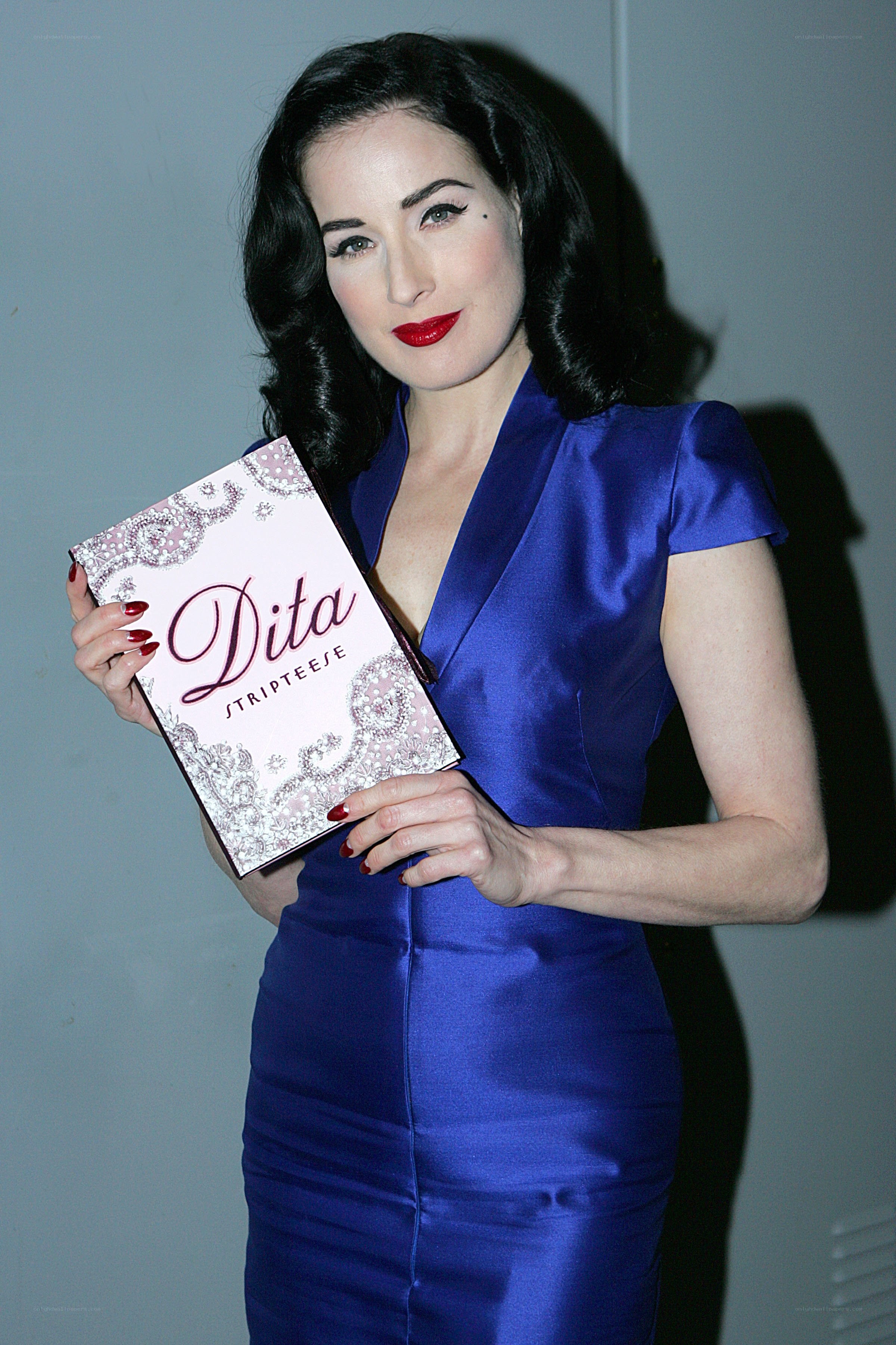 Dita Von Teese holding book