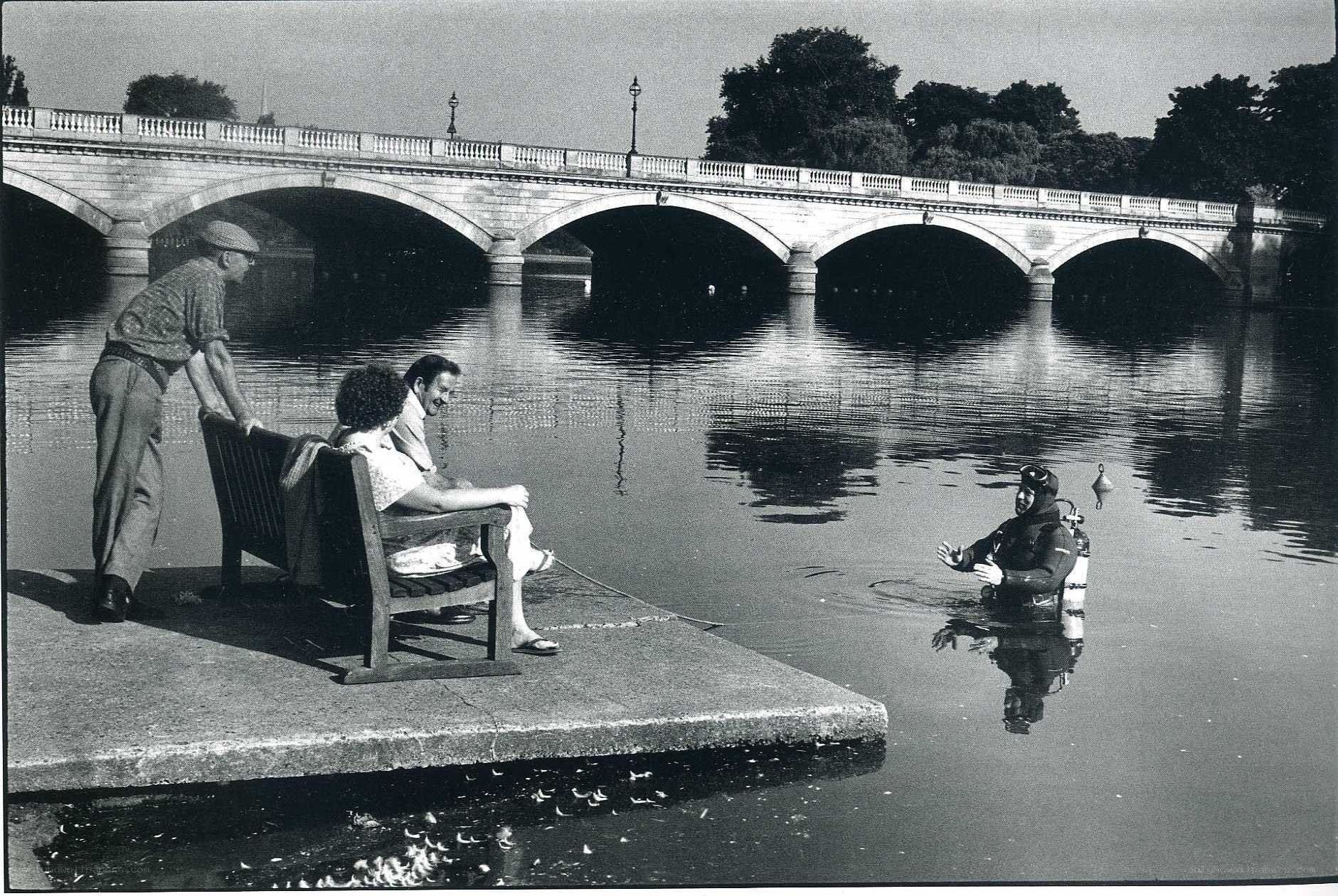 Diver and onlookers by a bridge