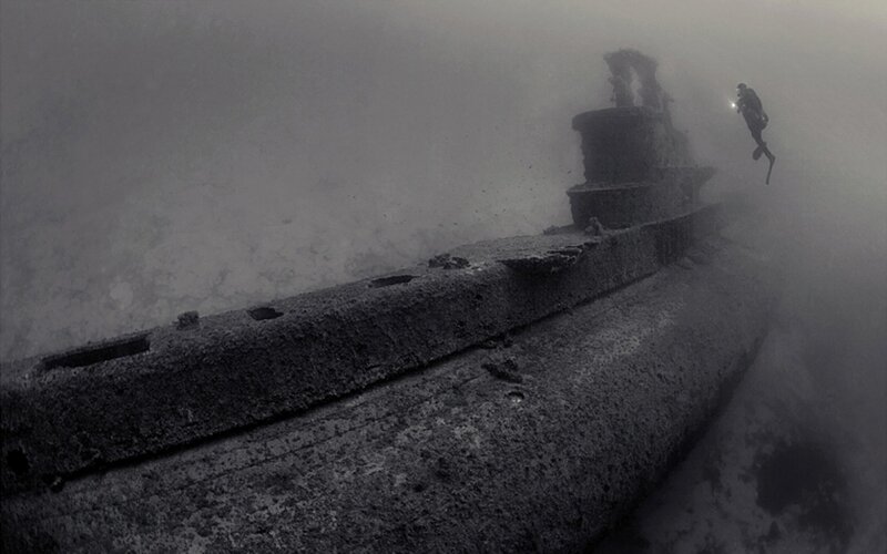 Diver explores sunken submarine