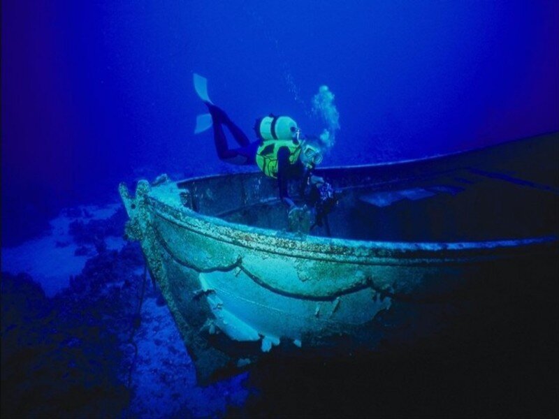 Diver Exploring Shipwreck — Blue