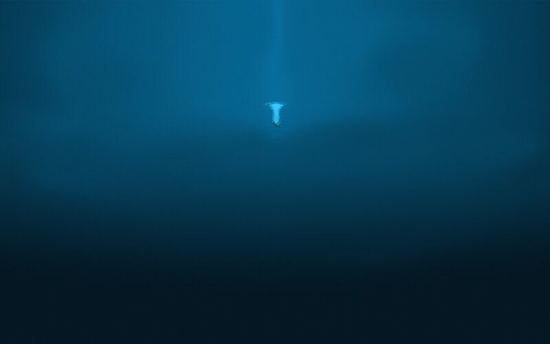 Diver in deep blue ocean
