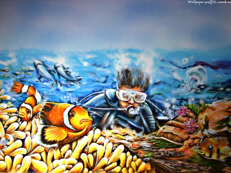 diver with clownfish underwater
