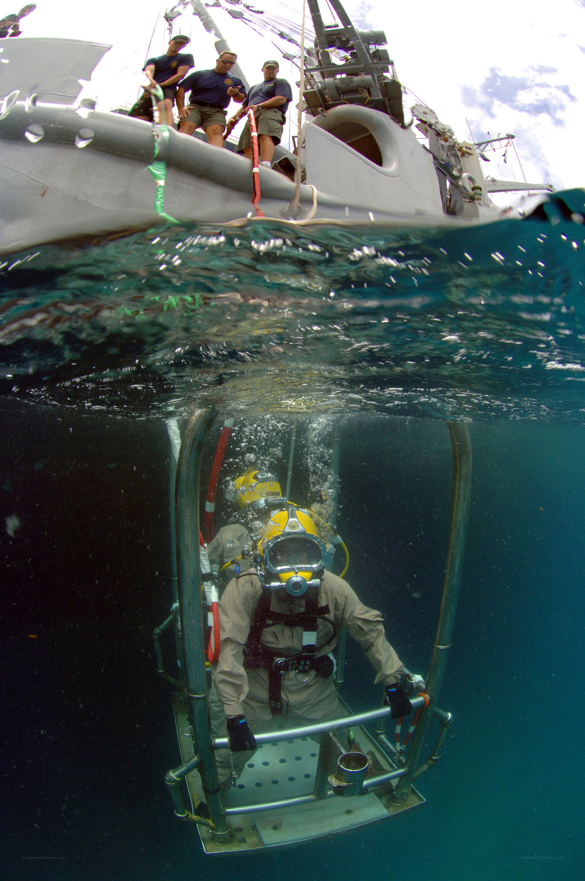 Divers being lowered into the water