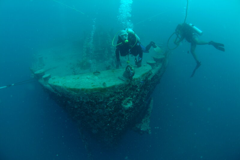 Divers exploring shipwreck