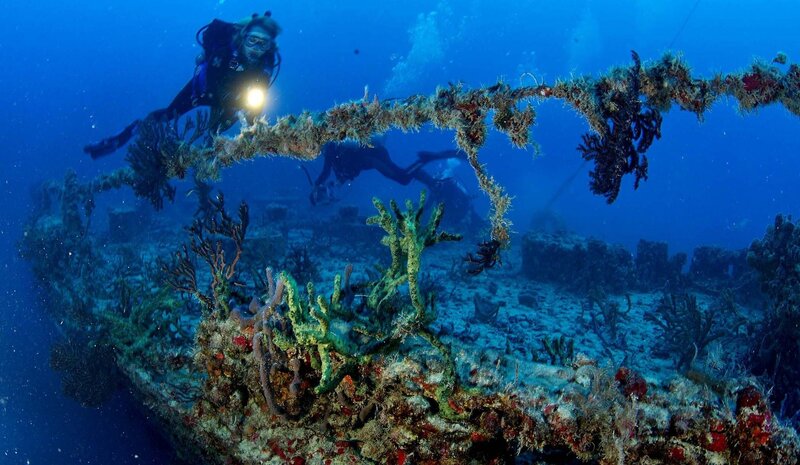 divers exploring shipwreck