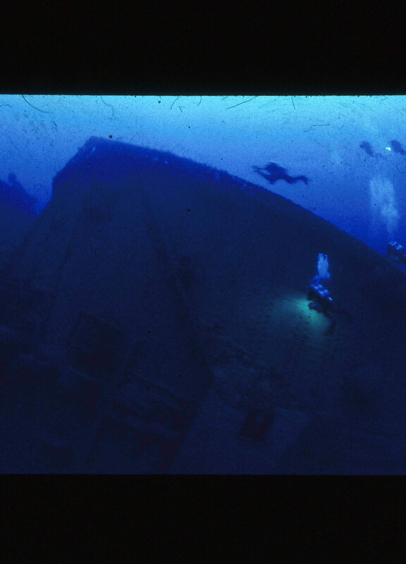 Divers Exploring Shipwreck — Blue, Dark