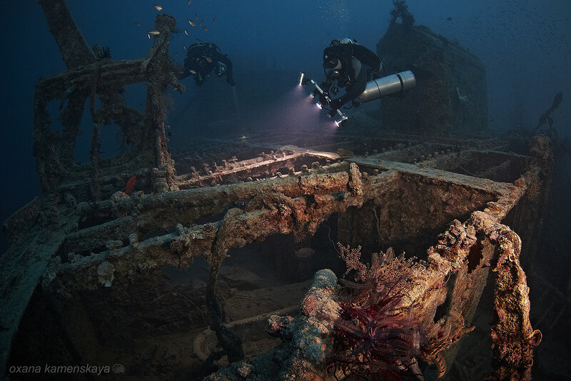 Divers Exploring Shipwreck — Blue, Dramatic, Photograph
