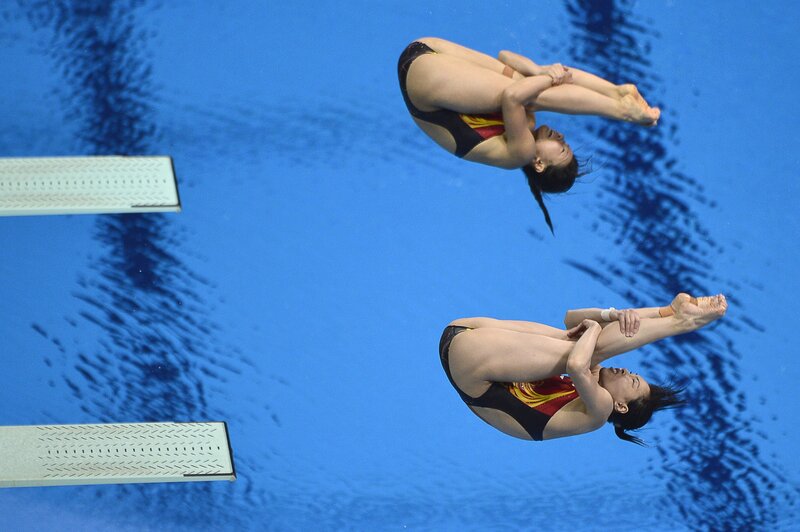 Divers in mid-air dive
