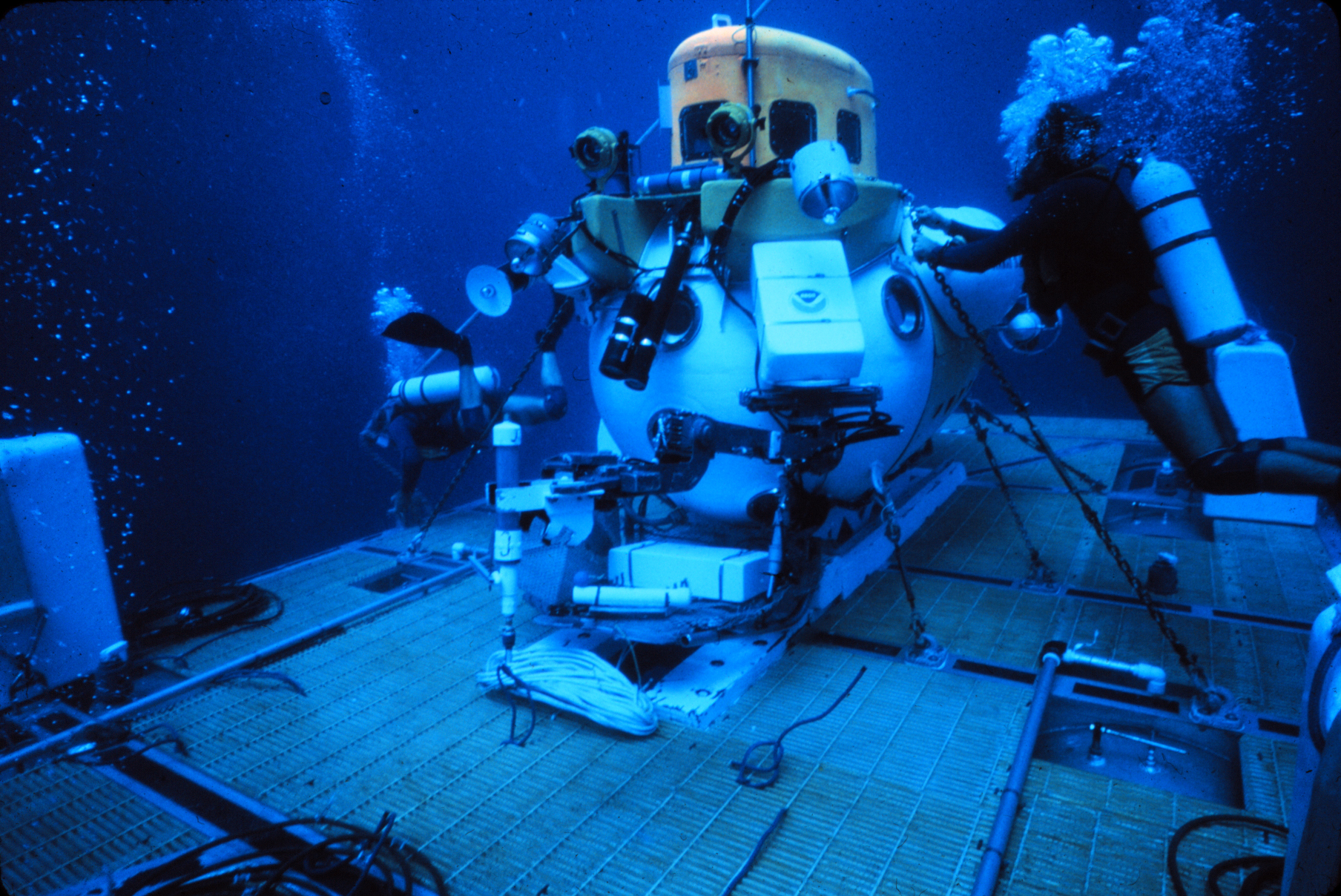 Divers with submersible underwater