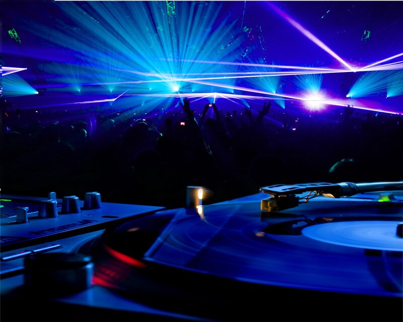 DJ at a nightclub with laser lights
